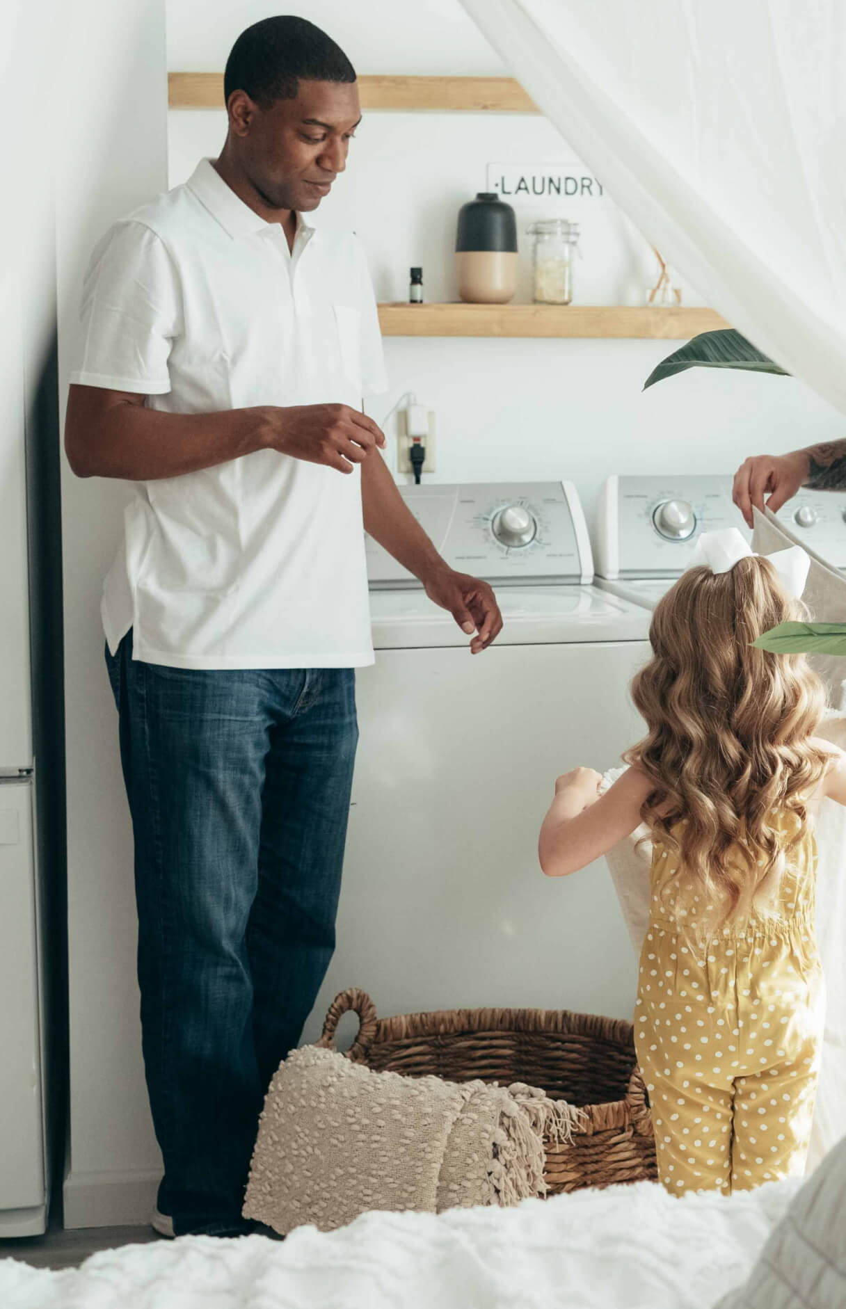 dad and daughter doing laundry